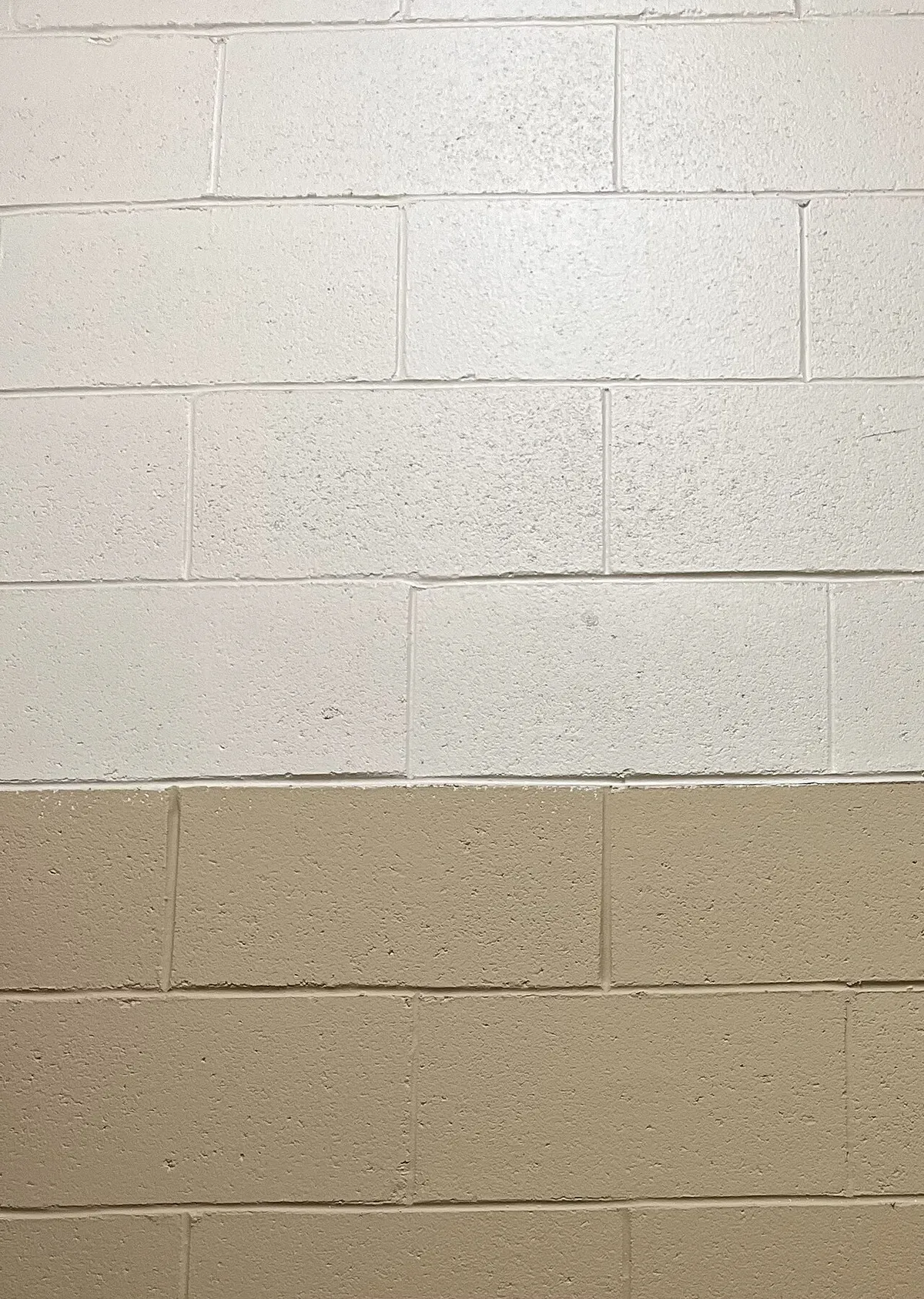 A painted concrete masonry unit wall in running bond, two colors, the kind of finished block a Queen Creek masonry contractor builds and repairs