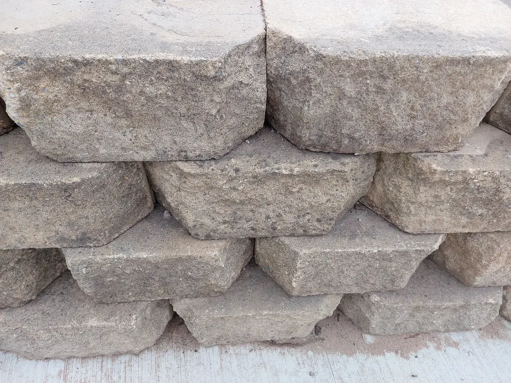 Close-up of stacked segmental concrete retaining wall blocks