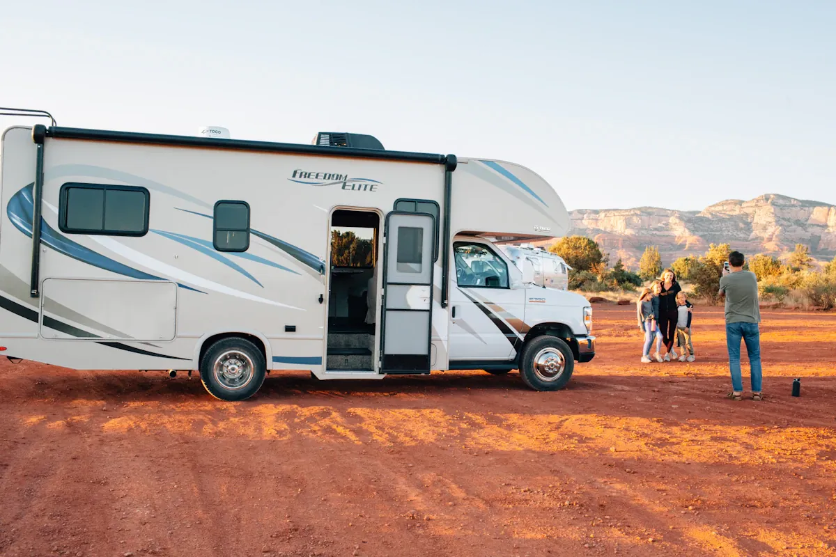 A Class C motorhome parked on red desert ground in Arizona, the size of rig an RV gate installation in Queen Creek has to clear